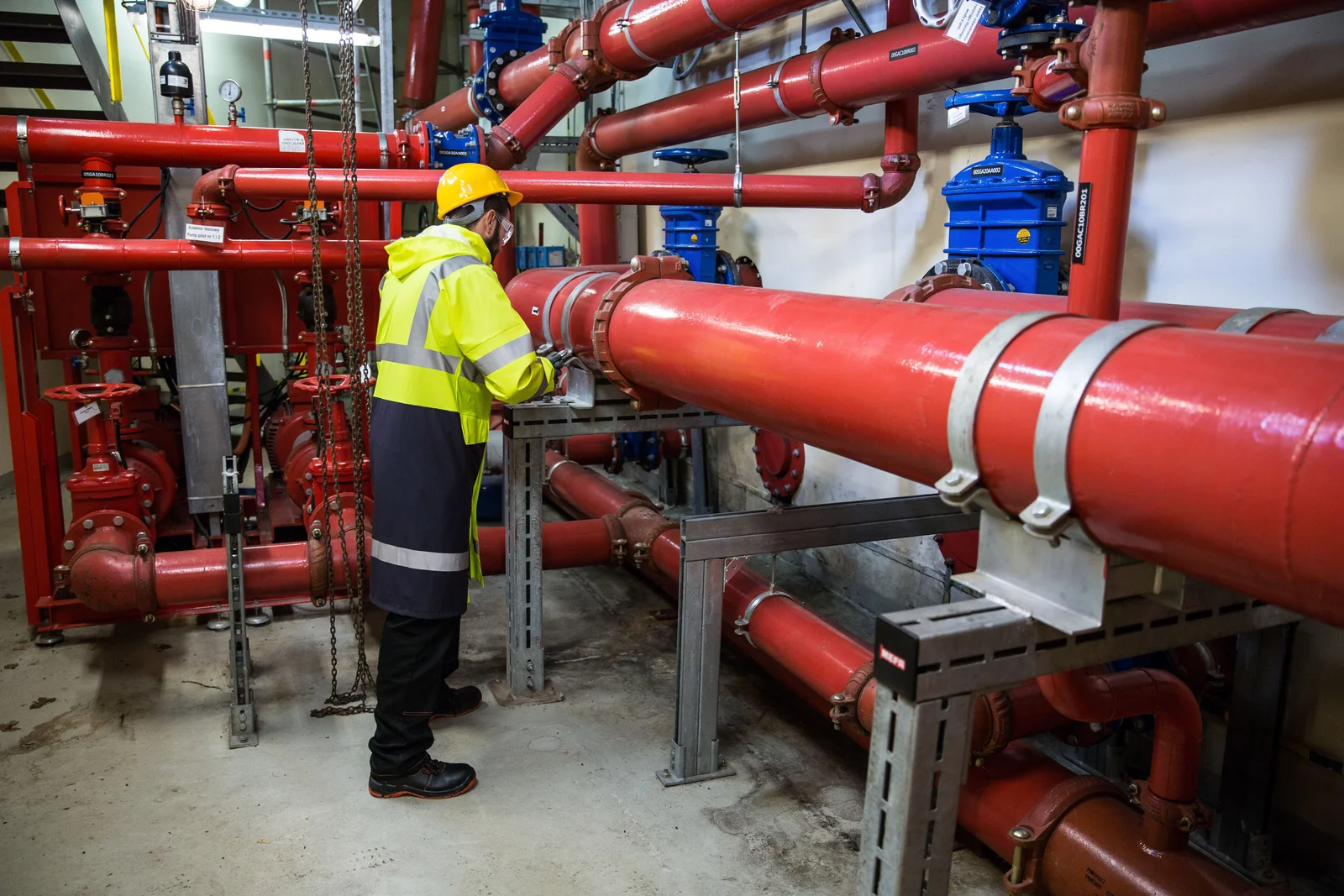 Licensed plumber working on commercial plumbing system